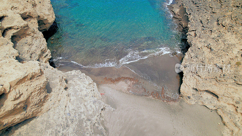 Aerial view of the hidden cove beach "La Rajita" at the natural reserve of "Monta?a Pelada" in Tenerife (Canary Islands). Drone shot